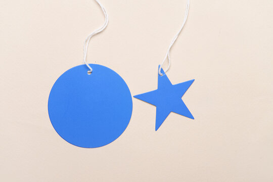 Blue blank tags with strings on yellow background