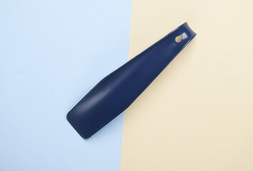 Shoehorn on pastel background. Top view
