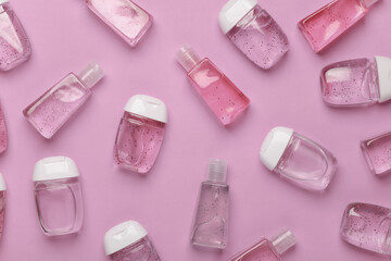 Antiseptic bottles on pink background. Top view