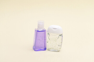 Antiseptic bottles on yellow background close up.