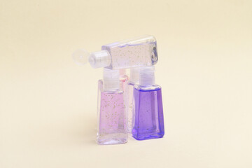 Antiseptic bottles on yellow background close up.