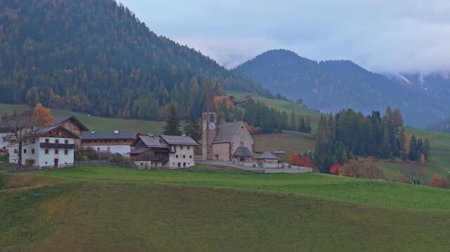 Drone view of Santa Maddalena in Val di Funes, Dolomites, cloudy weather.