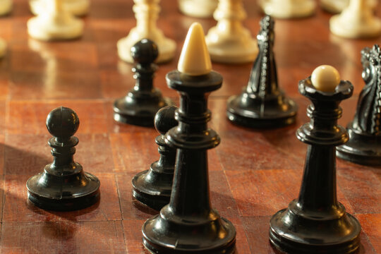 A close-up of the arrangement of chess pieces on the board.
