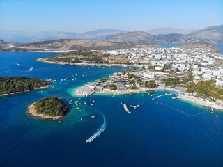 Ksamil, mass tourism vacation resort town in Southern Albania. Beach and coast drone view.