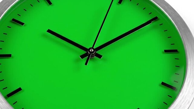 Close-up of a green clock with black hands and silver frame.