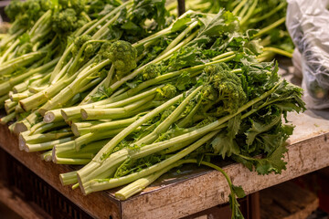 Cime di rapa, turnip greens, rapini or broccoli rabe in a street food market, green cruciferous vegetable, veggies, mediterranean cuisine, Puglia, Italy