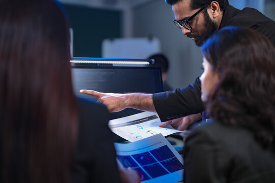 In a 24 7 Security Operations Center, a diverse incident response team works together under pressure, analyzing real-time threat intelligence data to defend against a live cyberattack.