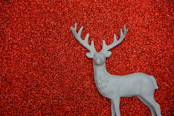  Christmas Reindeer Figure on Shiny Red Background.
