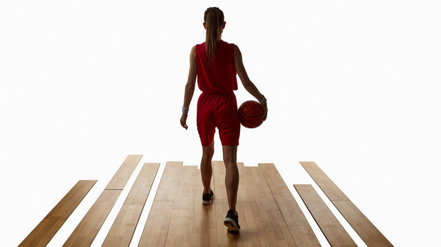 Female basketball player walking away with ball after game reflection. Concept of balance, determination, confidence, and purpose for sports and lifestyle communication.