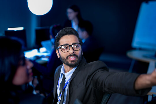A digital marketing team conducts a late-night strategy session. A lead strategist uses a tablet to review SEO performance, PPC campaign analytics, and content marketing results.