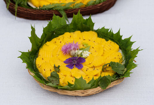 Slices of Jani cheese or Caraway cheese placed on maple leaves in a wicker basket. Latvian sour milk cheese, traditionally eaten on Jani, the Latvian celebration of the summer solstice