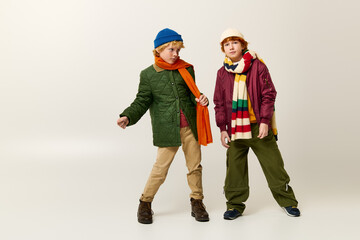 Stylish kids enjoying playful moments in creative outfits on a bright day
