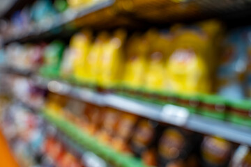 Blurred view of chip bags on market shelf.