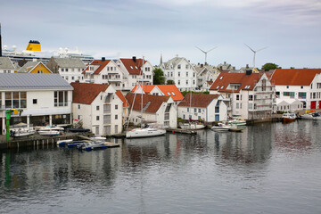 Traditional white wash wooden buildings along the waterfront. Smedasundet area and river in the centre of the town.  Haugesund, Norway.