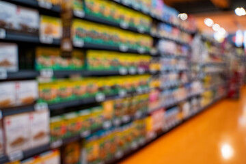 Blurred view of supermarket aisle and shelves.