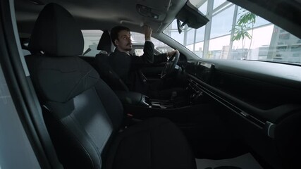 Car buyers exploring vehicles with sales agent assistance at dealership