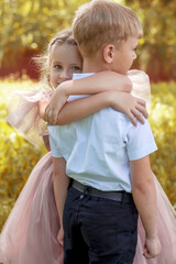 Sweet Embrace A Young Girl Hugs Her Friend Outdoors