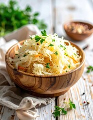 Close Up of Sauerkraut Salad in Wooden Bowl on White Wooden Table with Garnishes