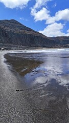 Black sand, Atlantic waves and dramatic cliffs at Playa de La Laja, Gran Canaria, Canary Islands, Spain.