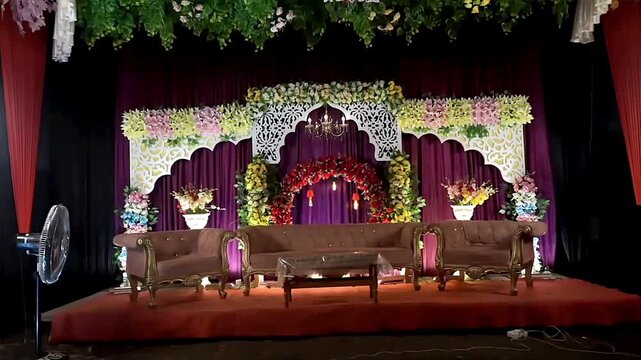 Luxurious wedding stage decor with ornate floral arch sofas and chandelier elegant event setup