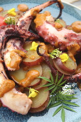 Grilled octopus with golden potatoes and creamy rocoto sauce—a bold and flavorful seafood dish showcasing the richness of Peruvian cuisine.