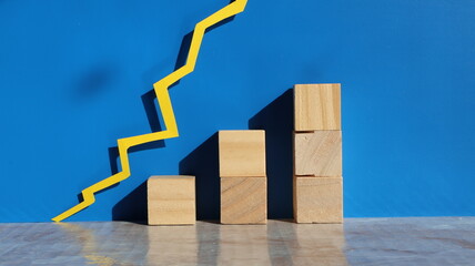 Blank wood blocks for copy space, with graph line and blue background.