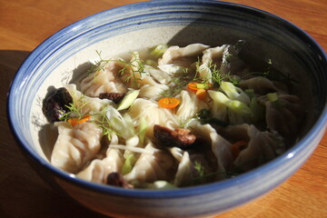 Dumpling soup with tender mushrooms and soft noodles in a savory broth—a warm, comforting bowl full of rich textures and umami flavor.