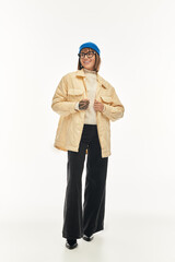 Obraz premium Young woman showcases trendy style in neutral tones and bright accessories while posing confidently