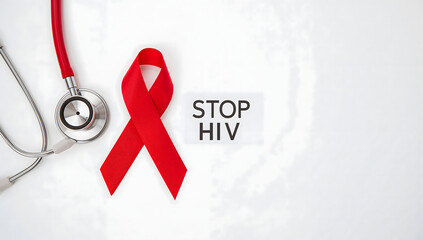 Stop HIV awareness concept with a red ribbon and stethoscope on a white background, a symbol of solidarity for World AIDS Day