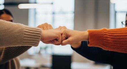 Two Business Professionals United in a Fist Bump, Signifying Teamwork and Collaboration in the Workplace