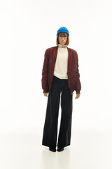 Fashionable young woman showcases unique style in a bright setting