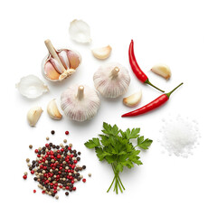Diverse fresh cooking ingredients: garlic, chili, parsley, spices.