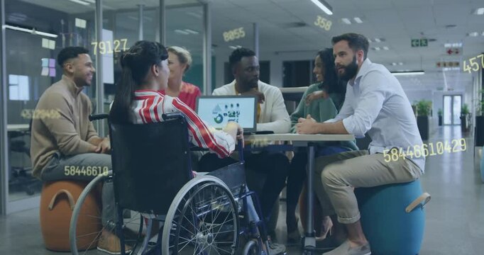 Wheelchair user tapping tablet chart team reacting reaching business goal with overlays over tablet