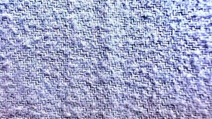 close-up of blue herringbone fabric texture with intricate zigzag weave pattern and soft fuzzy...
