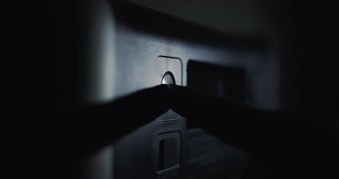 A hand presses the power button on the power station. Video contains sound.