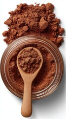 Cocoa powder displayed in a glass jar with a wooden spoon, surrounded by loose cocoa powder, highlighting its rich texture and color for baking and cooking