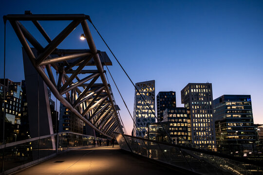 Architecture cityscape of Barcode Oslo featuring skyline night bridge structure and lights that build a striking urban scene for modern visual narratives.