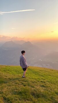 Sunset hike with a person walking on the trail and amazing view over Lake Lucerne on the Stoos