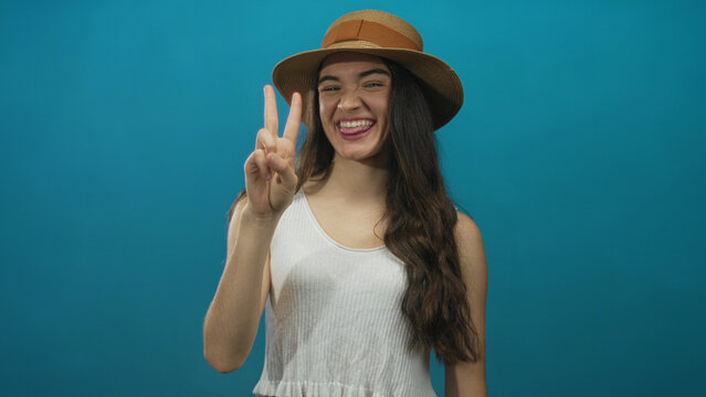 Teenage hispanic woman holds hand displaying sequential finger count in studio session; counting education joy.