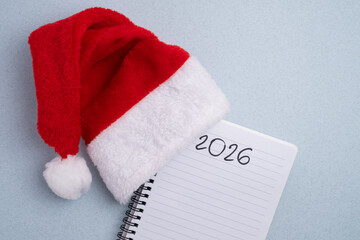 New Year 2026 planning. Santa hat, notebook, and snowflakes for resolutions and goals