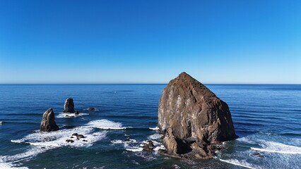 Haystack rock and pillars, sunny day at Cannon Beach