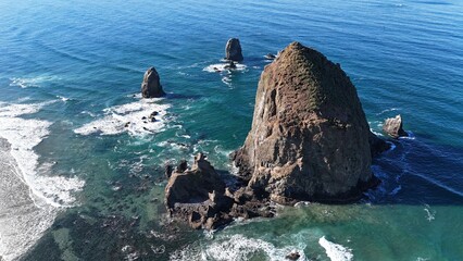 Haystack rock and pillars, sunny day at Cannon Beach