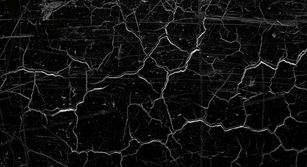 A dark, textured surface covered in a network of fine, weblike cracks, resembling dried mud or aged paint, with a gritty, distressed appearance