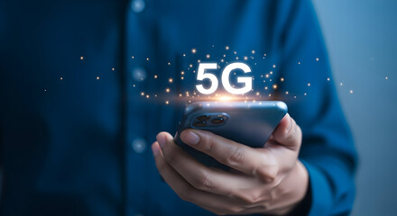 Person holding a smartphone displaying 5g technology with glowing particles showcasing fast mobile network connectivity and modern communication on a blue background for digital innovation and technol