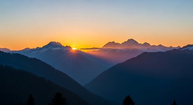 Majestic mountain range silhouette at sunrise with golden sky and light rays