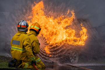 Naklejka premium Firefighters control a large blaze at an accident scene