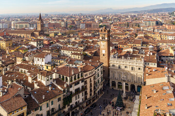 A panorama photographed from above the city of Verona in Italy The sky is blue and the Alpine panorama is visible in the background