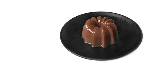 Chocolate Pudding Dessert Dish on a Black Plate. Food Photography Presentation. Isolated on White Background