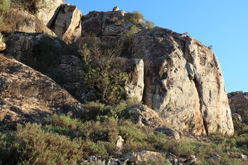 Beautiful mountain landscapes; rocky mountains; valleys; desert flora; blue skies;