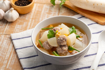 Clear Soup with White Radish and minced pork ball in white bowl.Thai food.